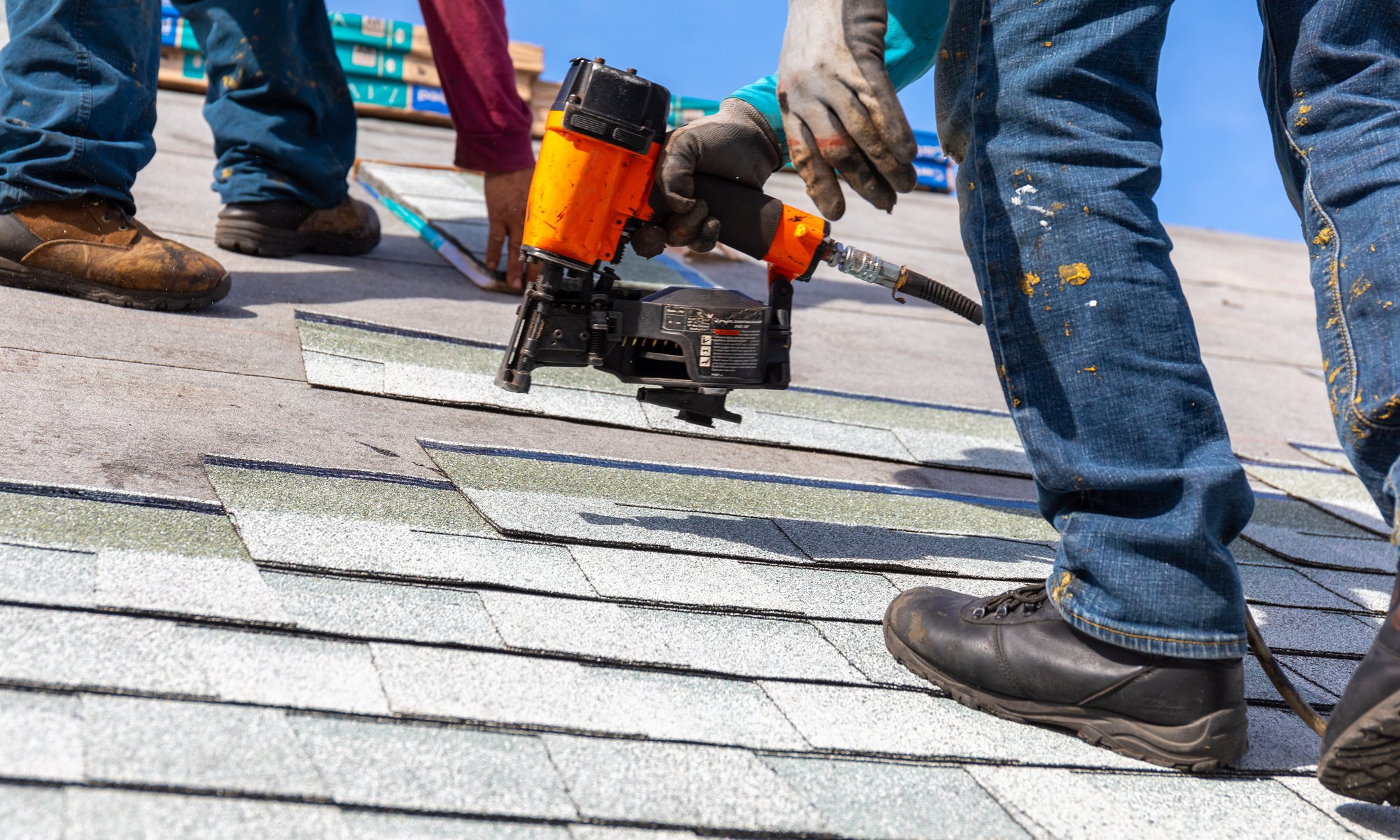 Roofing installing shingles during a roof replacement