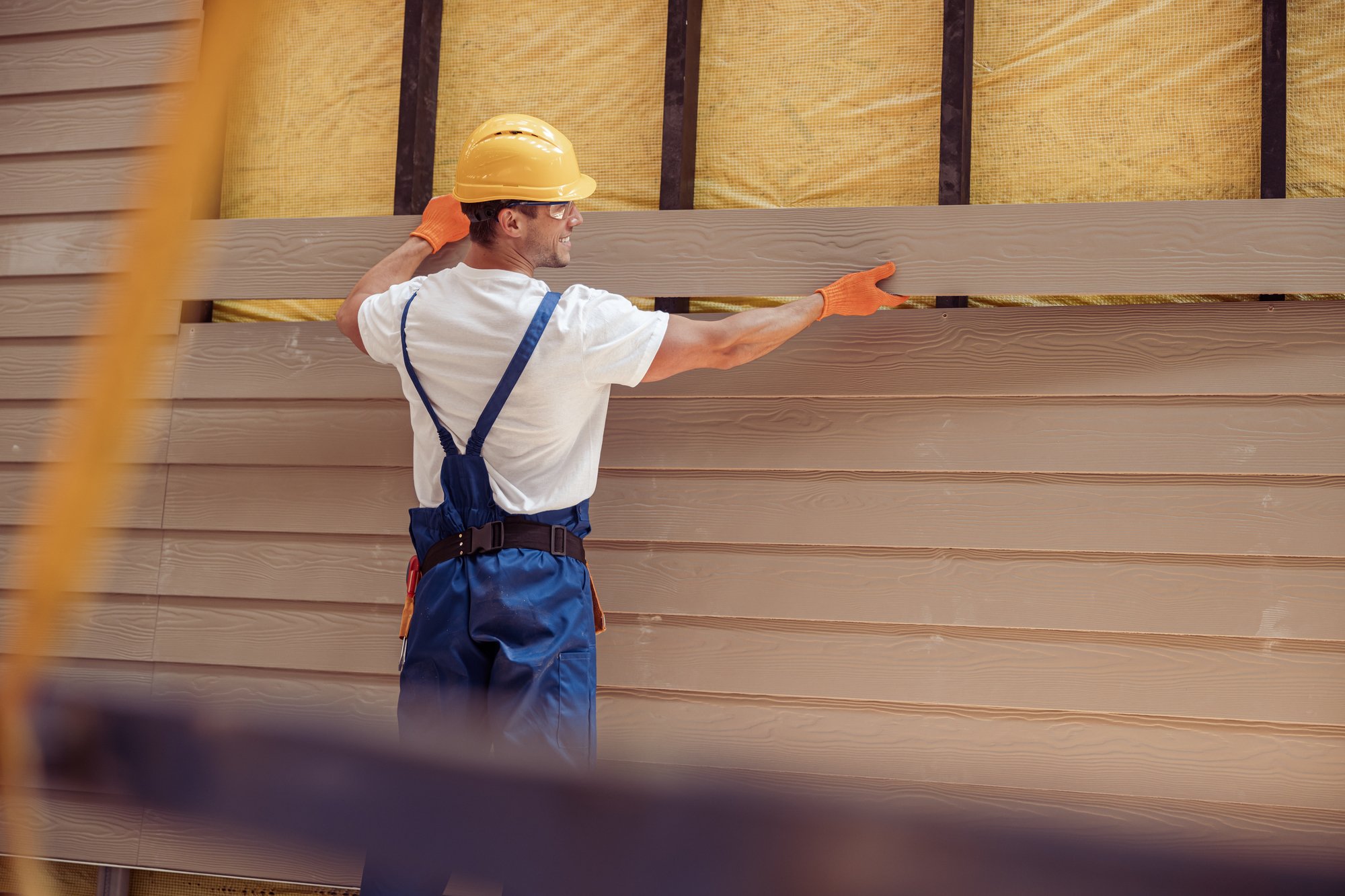 Contractor installing new siding on a house