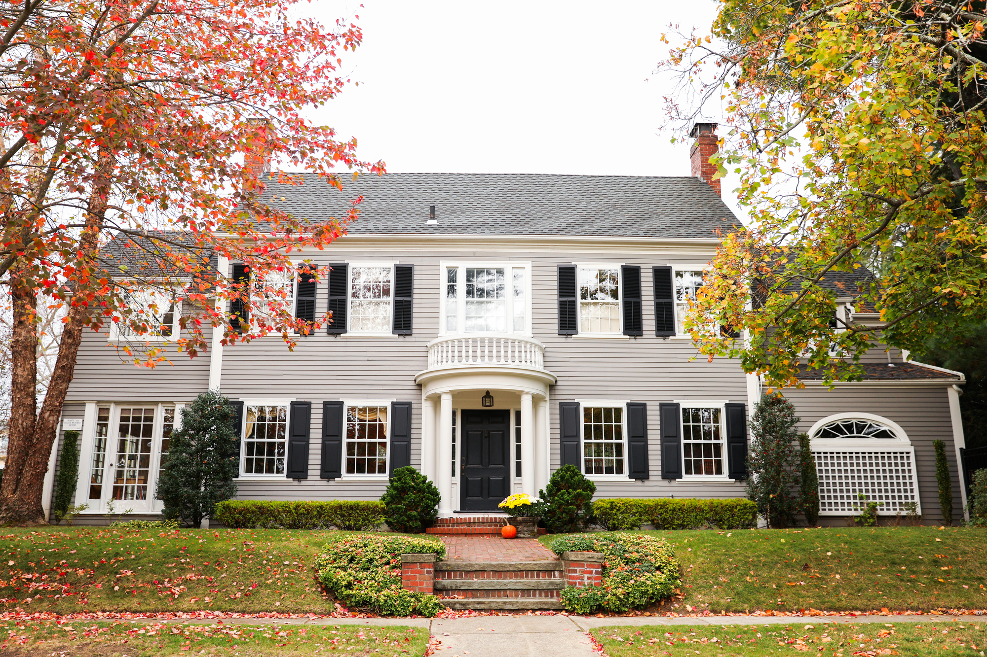 Two-story house with an asphalt shingle roof and a balcony