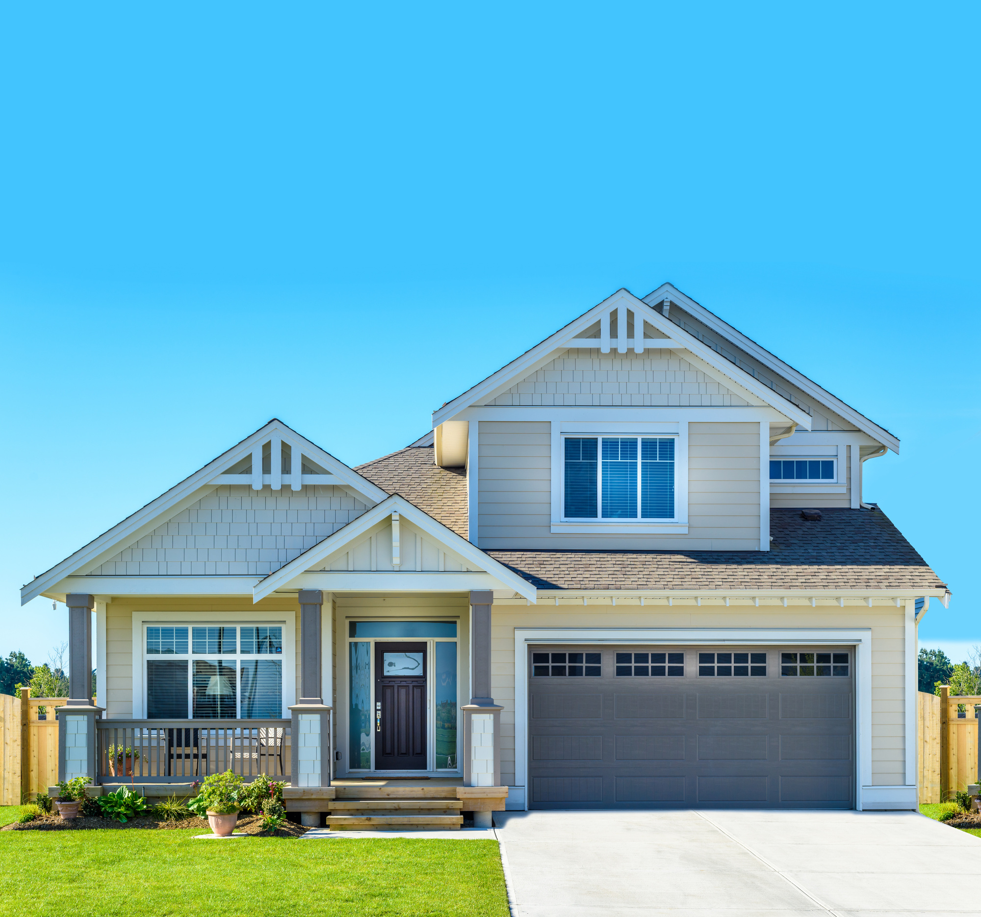Two-story house with a small porch and a shingle peaked roof