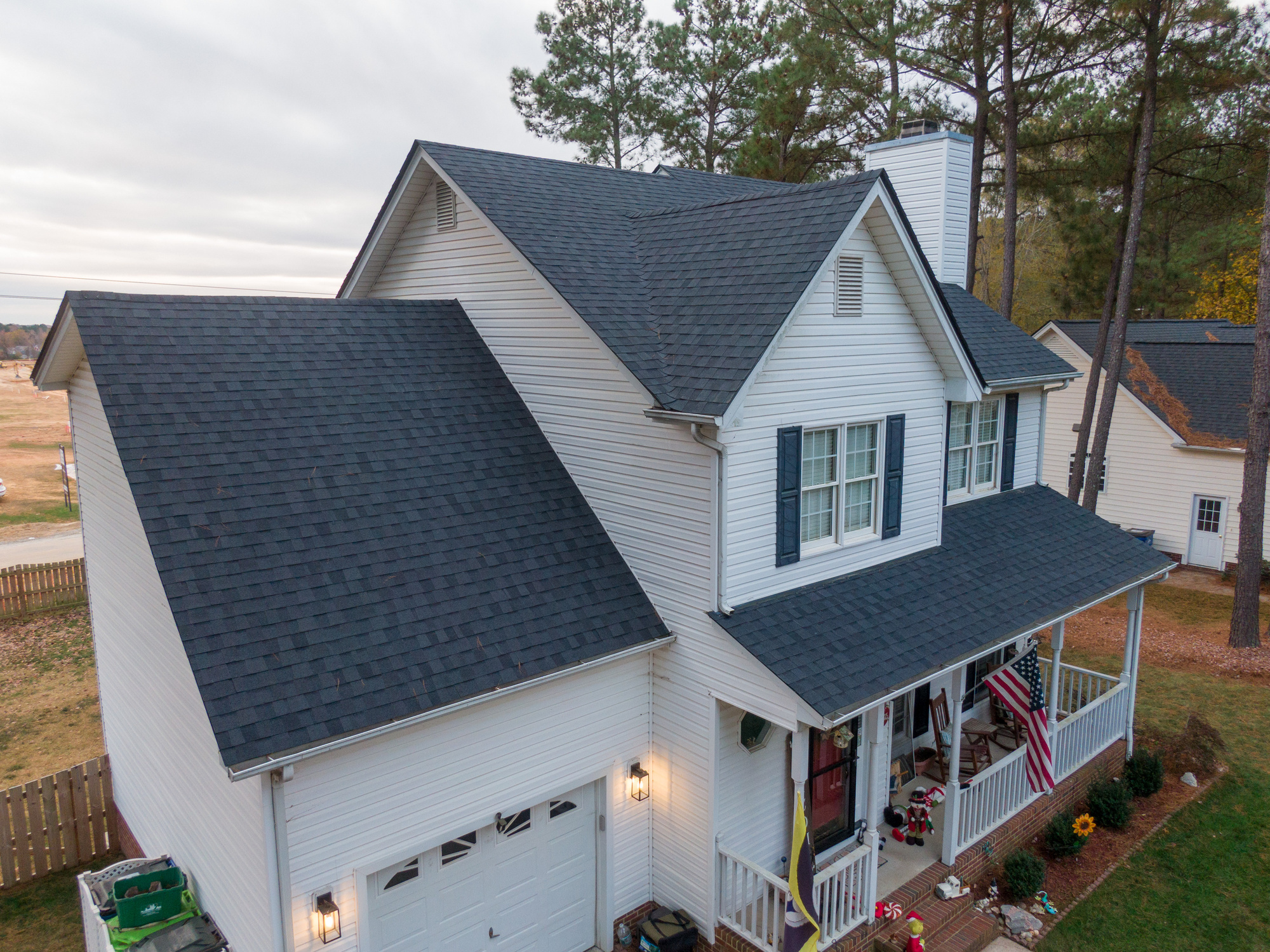 Two-story white house with an asphalt shingle roof