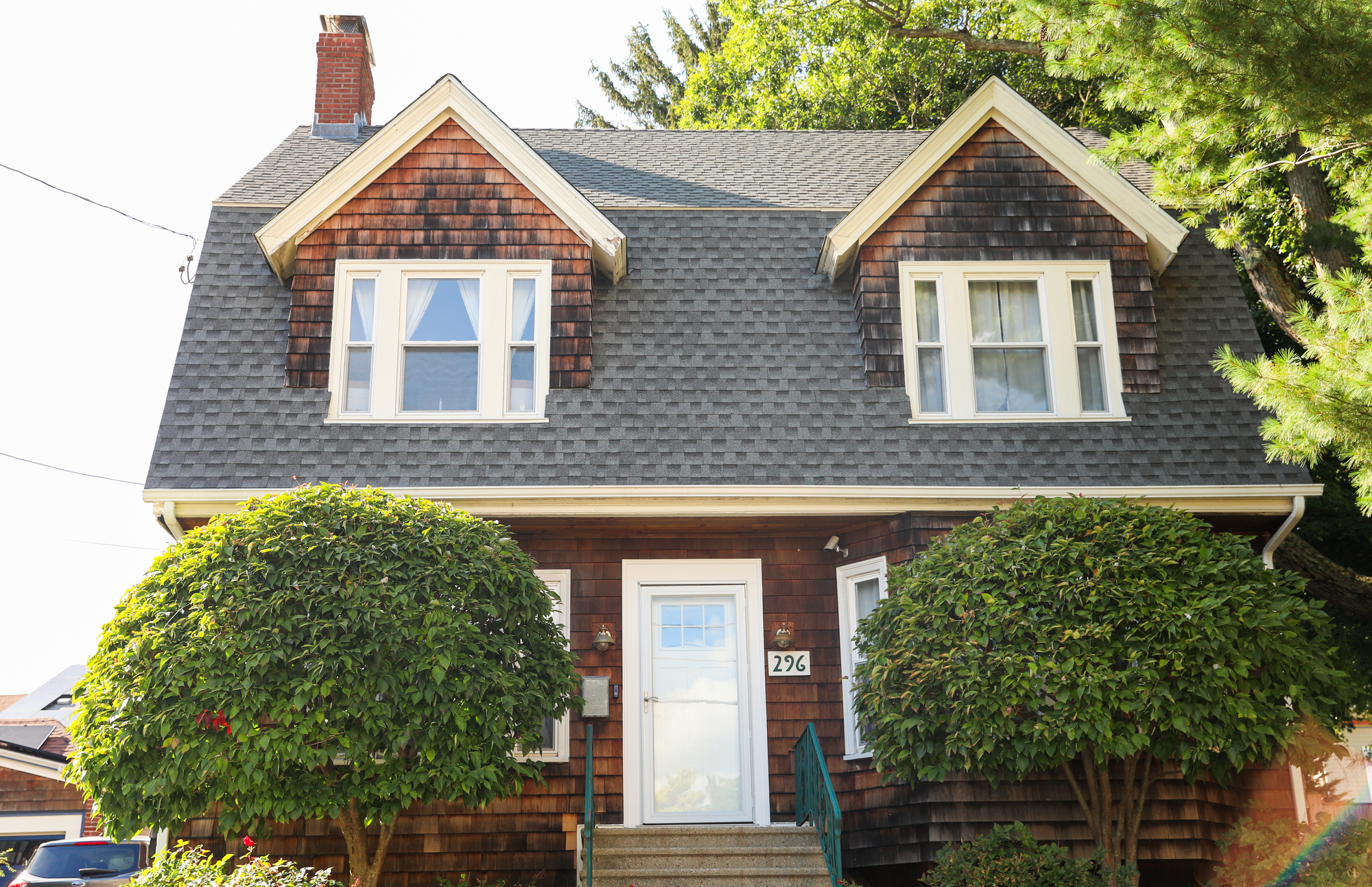 A house with cedar siding and a new gray asphalt shingle roof in Southwestern Ohio.