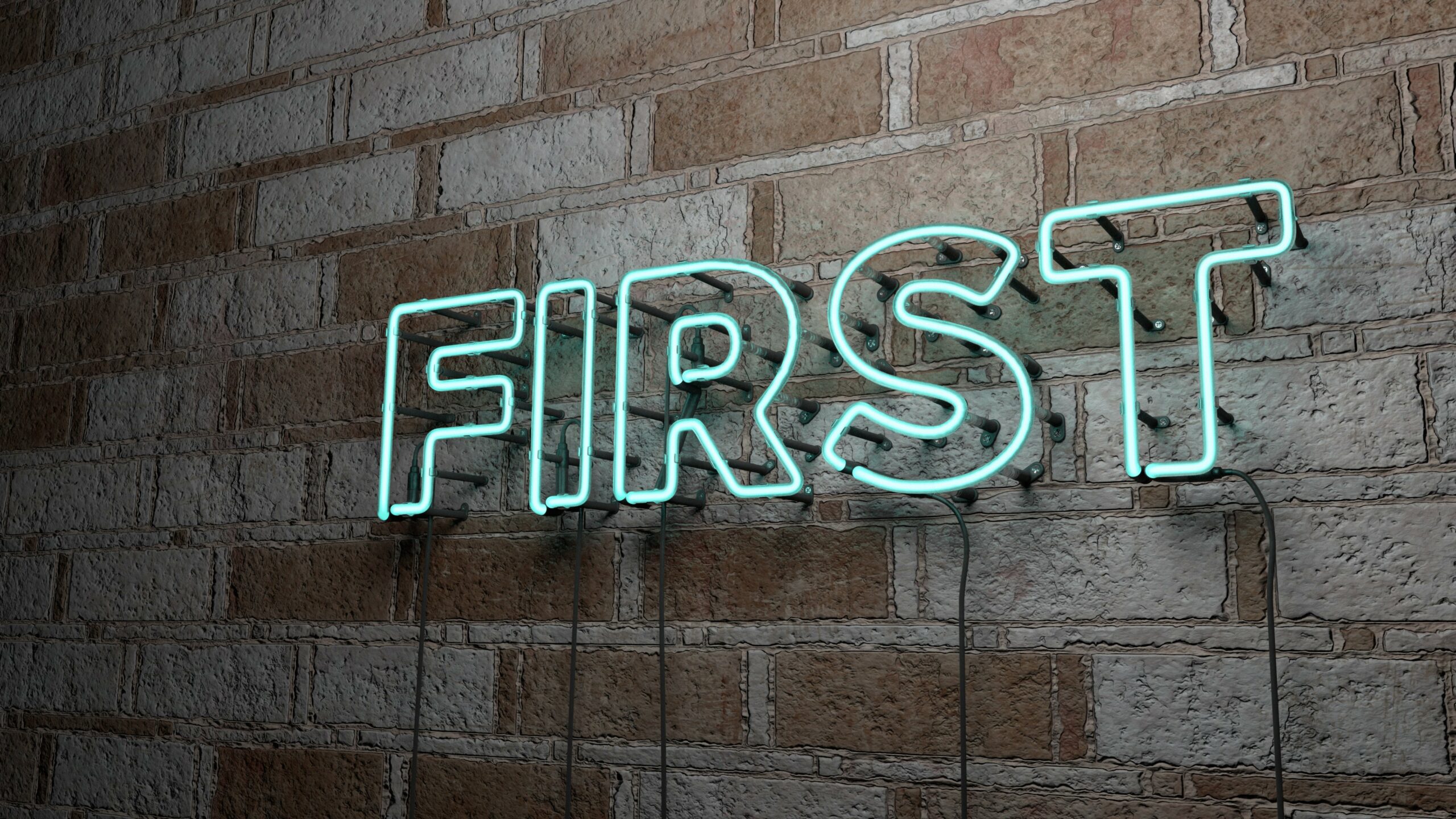 A glowing neon sign with the word “First” written against a brick wall.