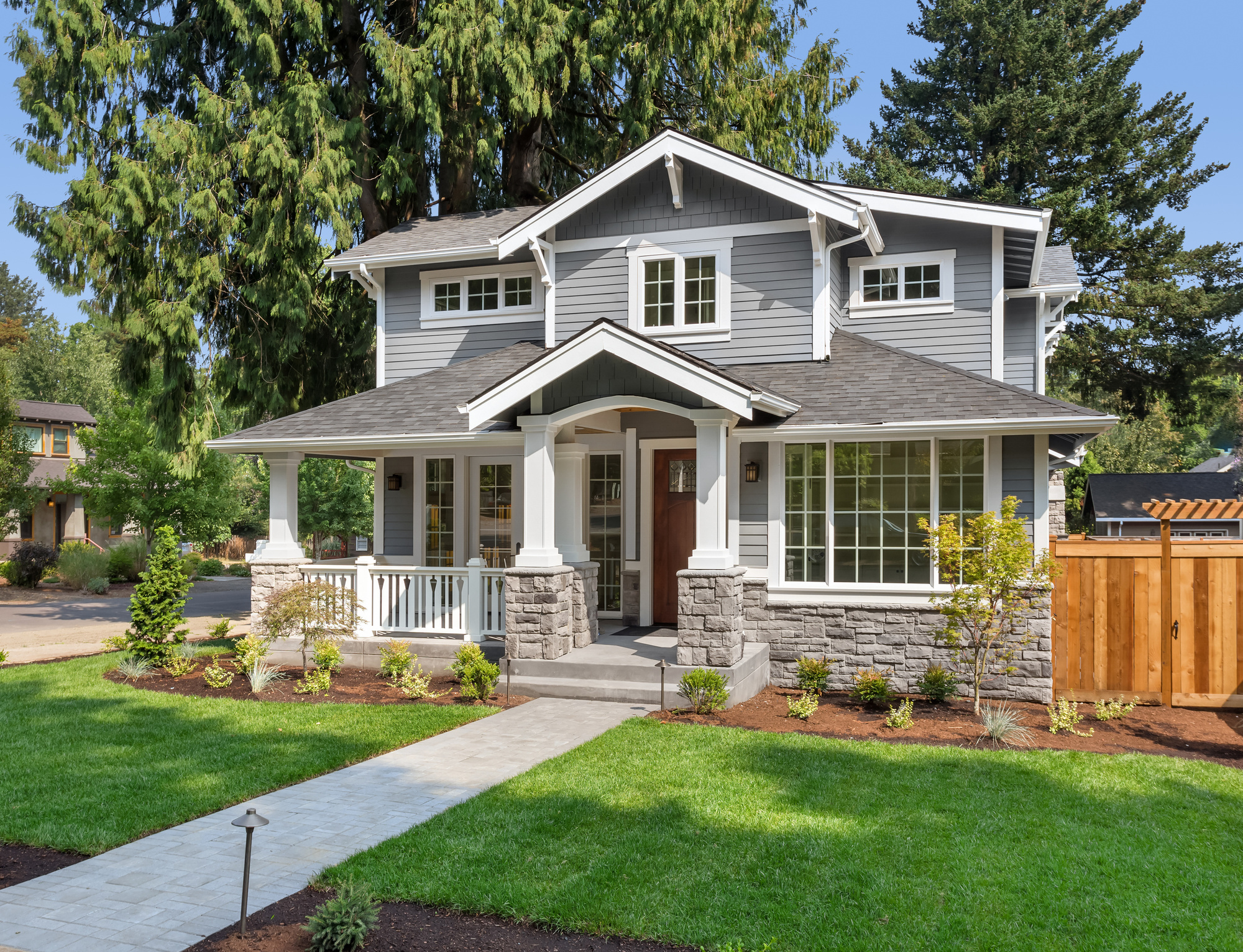 White horizontal vinyl siding on a house with three small windows