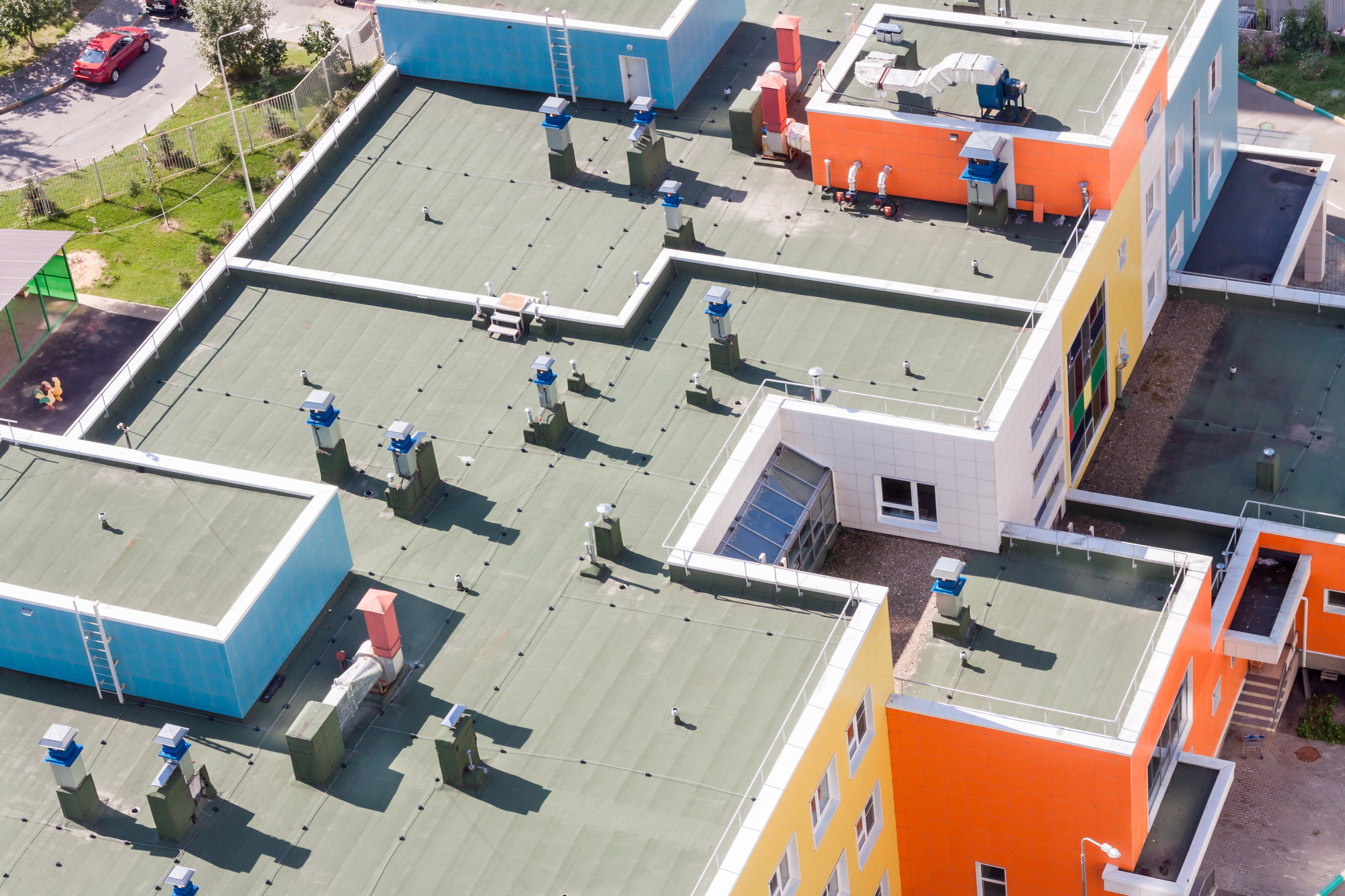 Aerial view of a roof on a commercial building with air conditioning units on top