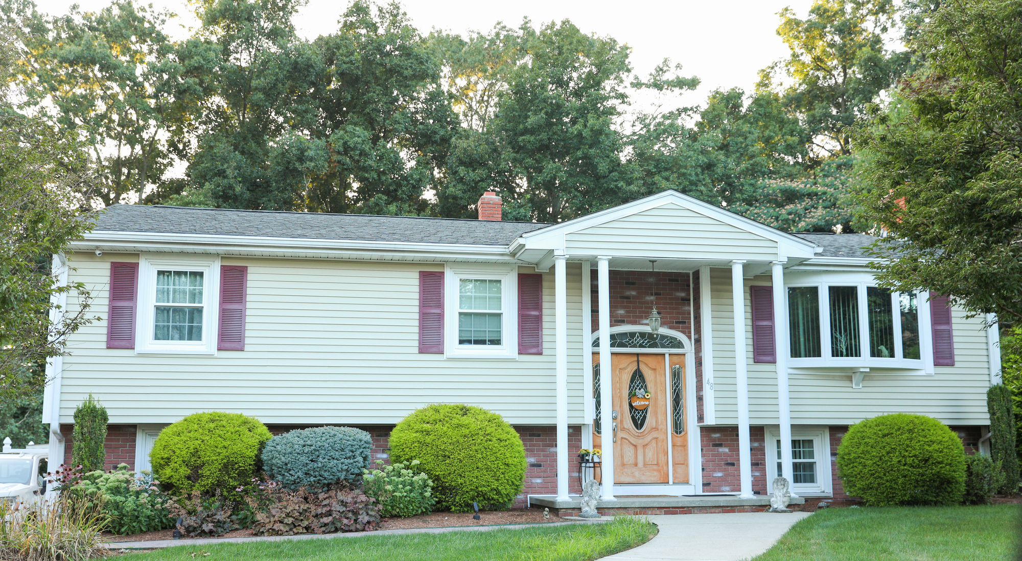 Single-family home with light-colored vinyl siding .