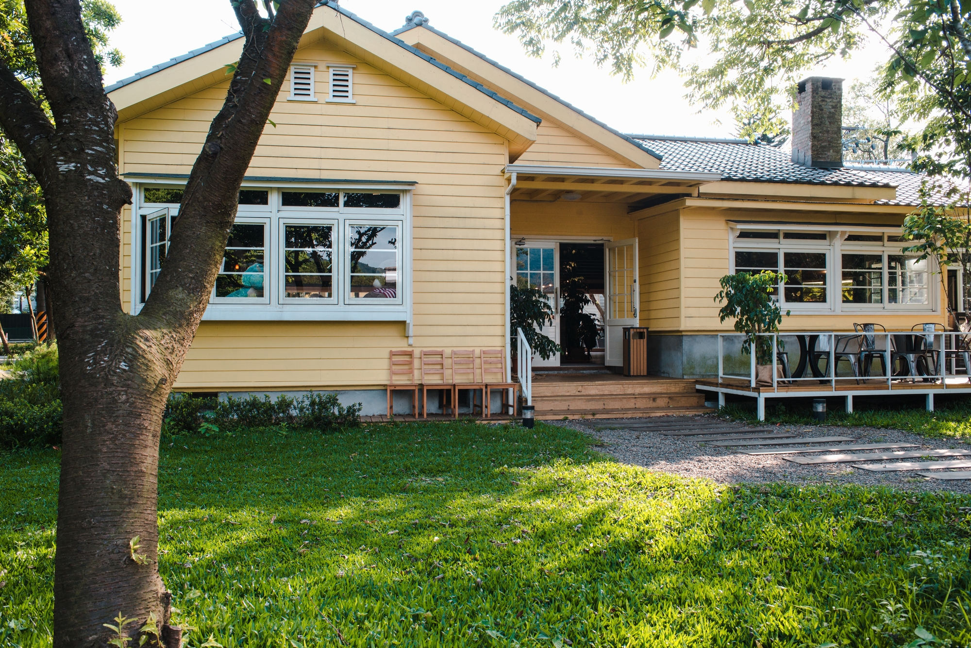 Yellow house with a metal roof and a porch