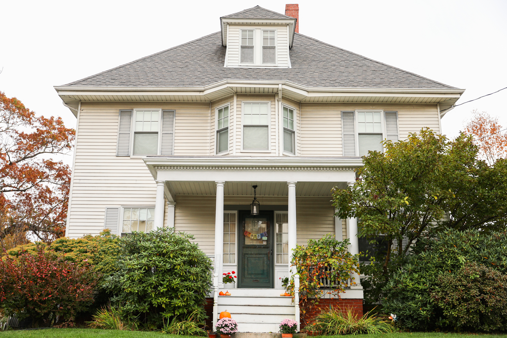 Suburban home with white siding and asphalt shingle roofing.