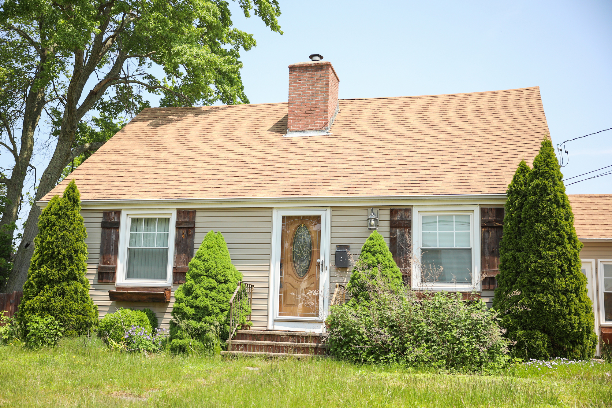 A house with a light brown asphalt shingle roof in Southwestern Ohio.