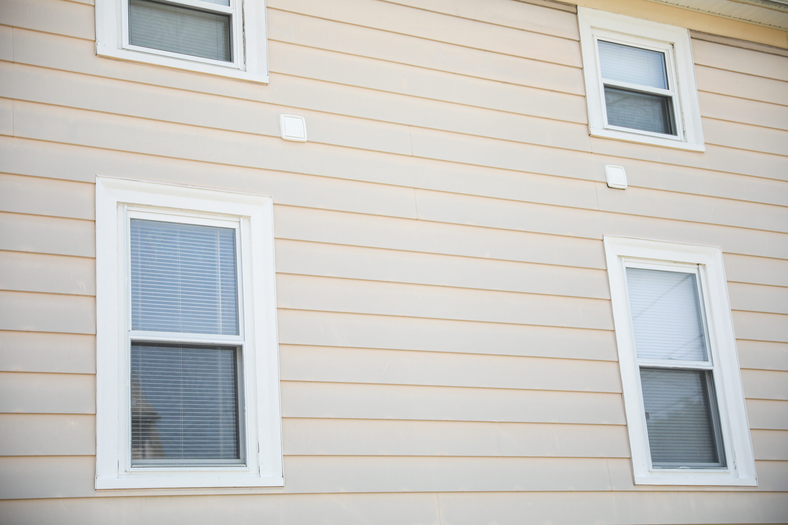 Yellow two-story house with four windows