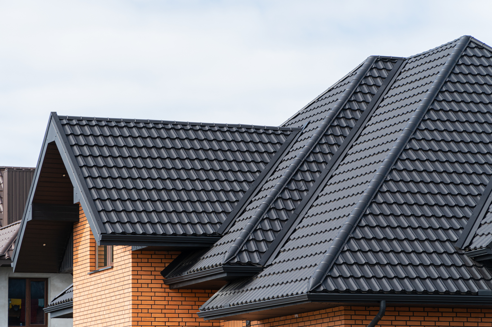 Steel tile roof on a brick house